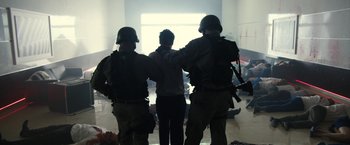 Movie still from “The Belko Experiment” (2016), directed by Greg McLean – A group of men in uniform standing next to each other in a room; Wide shot, Low angle