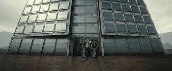 Movie still from “The Belko Experiment” (2016), directed by Greg McLean – A group of men standing in front of a building; Extreme Wide shot, Low angle