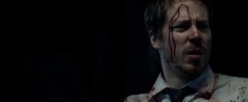 Movie still from “The Belko Experiment” (2016), directed by Greg McLean – A man with blood all over his face; Close Up shot, Over the shoulder angle