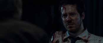 Movie still from “The Belko Experiment” (2016), directed by Greg McLean – A person with blood all over his face; Close Up shot, Over the shoulder angle