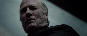 Movie still from “The Belko Experiment” (2016), directed by Greg McLean – An old man with white hair and a bald head; Close Up shot, Low angle