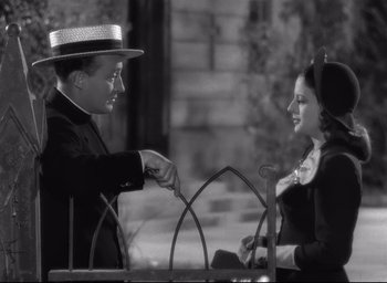 Movie still from “The Bells of St. Mary's” (1945), directed by Leo McCarey – A man and a woman sitting on a bench; Medium shot, High angle