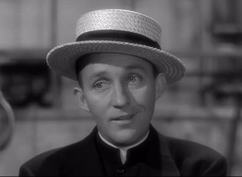 Movie still from “The Bells of St. Mary's” (1945), directed by Leo McCarey – A black and white photo of a man wearing a straw hat; Close Up shot, Low angle