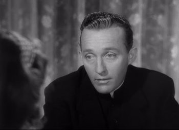 Movie still from “The Bells of St. Mary's” (1945), directed by Leo McCarey – A black and white photo of a man wearing a priest's outfit; Close Up shot, High angle