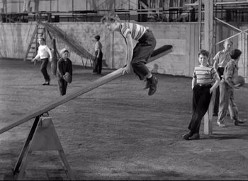 Movie still from “The Bells of St. Mary's” (1945), directed by Leo McCarey – A group of young boys playing a game on a teeter - totter; Wide shot, High angle