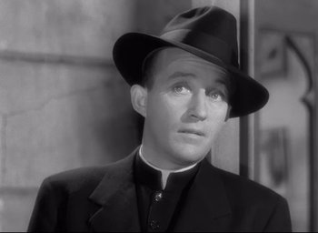 Movie still from “The Bells of St. Mary's” (1945), directed by Leo McCarey – A black and white photo of a man wearing a hat; Close Up shot, Low angle