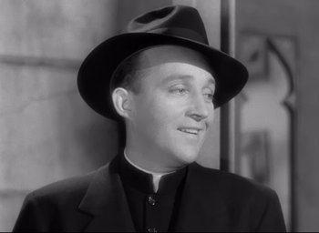 Movie still from “The Bells of St. Mary's” (1945), directed by Leo McCarey – A man wearing a black hat and a black suit; Close Up shot, Low angle
