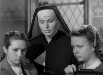 Movie still from “The Bells of St. Mary's” (1945), directed by Leo McCarey – A woman in a nun's outfit with two other women; Close Up shot, Low angle