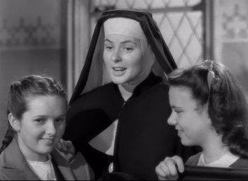 Movie still from “The Bells of St. Mary's” (1945), directed by Leo McCarey – A woman in a nun's outfit with two other women; Medium shot, Low angle