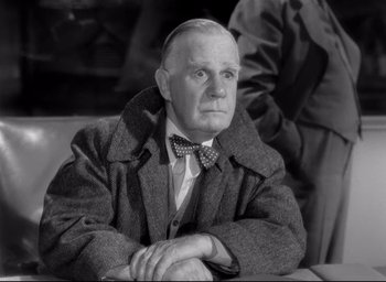 Movie still from “The Bells of St. Mary's” (1945), directed by Leo McCarey – An older man wearing a coat and bow tie; Close Up shot, Low angle