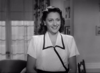 Movie still from “The Bells of St. Mary's” (1945), directed by Leo McCarey – A black and white photo of a woman smiling; Medium shot, Low angle