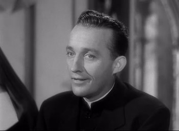 Movie still from “The Bells of St. Mary's” (1945), directed by Leo McCarey – A black and white photo of a man in a priest's outfit; Close Up shot, Low angle