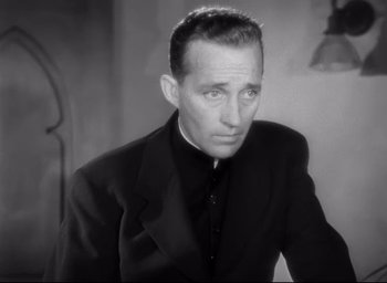 Movie still from “The Bells of St. Mary's” (1945), directed by Leo McCarey – A black and white photo of a man wearing a suit; Close Up shot, Low angle