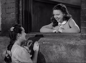 Movie still from “The Bells of St. Mary's” (1945), directed by Leo McCarey – A woman is looking at another woman on a ledge; Medium shot, High angle