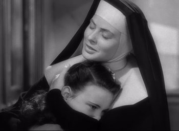 Movie still from “The Bells of St. Mary's” (1945), directed by Leo McCarey – A nun holding a young girl in her arms; Close Up shot, High angle