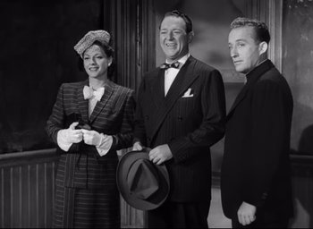 Movie still from “The Bells of St. Mary's” (1945), directed by Leo McCarey – A man and two women standing next to each other; Medium shot, High angle