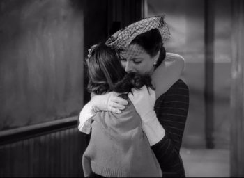 Movie still from “The Bells of St. Mary's” (1945), directed by Leo McCarey – A woman and a child hug each other in a black and white photo; Medium shot, High angle