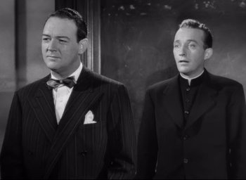 Movie still from “The Bells of St. Mary's” (1945), directed by Leo McCarey – A black and white photo of two men standing next to each other; Medium shot, Low angle