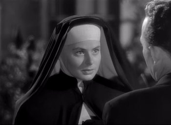 Movie still from “The Bells of St. Mary's” (1945), directed by Leo McCarey – A woman wearing a nun's habit with a veil over her head; Close Up shot, Over the shoulder angle