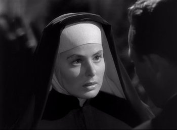 Movie still from “The Bells of St. Mary's” (1945), directed by Leo McCarey – A woman wearing a nun's habit and a veil; Close Up shot, Over the shoulder angle
