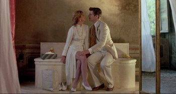 Movie still from “The Belly of an Architect” (1987), directed by Peter Greenaway – A man and a woman sitting next to each other on top of a bench; Wide shot, Overhead angle