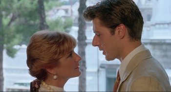 Movie still from “The Belly of an Architect” (1987), directed by Peter Greenaway – A man and a woman face to face in front of a window; Close Up shot, Low angle