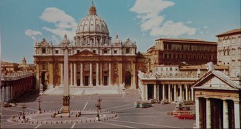 Movie still from “The Belly of an Architect” (1987), directed by Peter Greenaway – A view of a large building with a large dome in the center of it; Extreme Wide shot, High angle