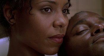 Movie still from “The Best Man” (1999), directed by Malcolm D. Lee – A woman's face with her hand on her face; Extreme Close Up shot, Low angle