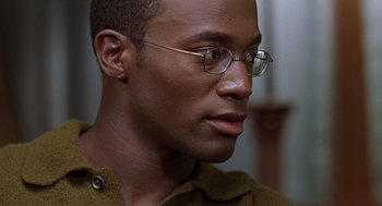 Movie still from “The Best Man” (1999), directed by Malcolm D. Lee – A person wearing glasses; Close Up shot, Over the shoulder angle