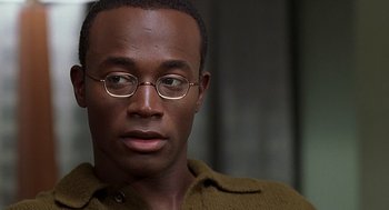 Movie still from “The Best Man” (1999), directed by Malcolm D. Lee – A person wearing glasses; Close Up shot, Over the shoulder angle