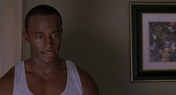 Movie still from “The Best Man” (1999), directed by Malcolm D. Lee – A person wearing a tank top; Close Up shot, Over the shoulder angle