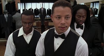 Movie still from “The Best Man” (1999), directed by Malcolm D. Lee – A group of young men standing next to each other in front of suits; Medium shot, Low angle