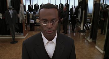 Movie still from “The Best Man” (1999), directed by Malcolm D. Lee – A man in a suit and tie; Close Up shot, Over the shoulder angle