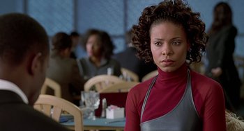 Movie still from “The Best Man” (1999), directed by Malcolm D. Lee – A woman in an apron standing in front of a group of diners; Close Up shot, Over the shoulder angle