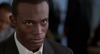 Movie still from “The Best Man” (1999), directed by Malcolm D. Lee – A person wearing a suit and tie; Close Up shot, Low angle