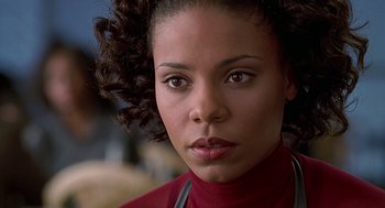 Movie still from “The Best Man” (1999), directed by Malcolm D. Lee – A person wearing a red shirt; Close Up shot, Over the shoulder angle