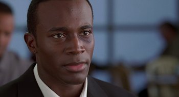 Movie still from “The Best Man” (1999), directed by Malcolm D. Lee – A person wearing a suit and tie; Close Up shot, Low angle