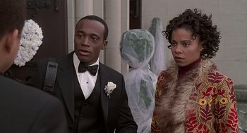 Movie still from “The Best Man” (1999), directed by Malcolm D. Lee – A man and a woman standing next to each other; Close Up shot, Over the shoulder angle