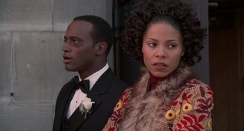 Movie still from “The Best Man” (1999), directed by Malcolm D. Lee – A man and a woman standing next to each other; Close Up shot, Over the shoulder angle