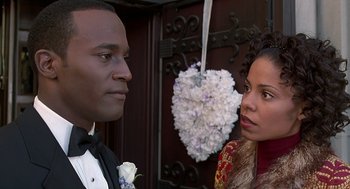 Movie still from “The Best Man” (1999), directed by Malcolm D. Lee – A man and a woman standing next to each other in formal wear; Close Up shot, Over the shoulder angle