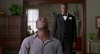 Movie still from “The Best Man” (1999), directed by Malcolm D. Lee – Two men in suits and ties standing in front of a mirror; Medium shot, Low angle