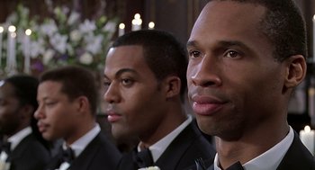 Movie still from “The Best Man” (1999), directed by Malcolm D. Lee – A group of men standing next to each other in suits; Close Up shot, Over the shoulder angle