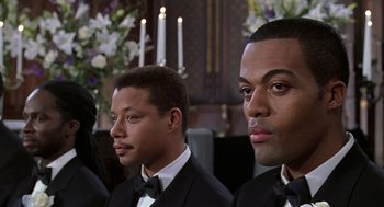 Movie still from “The Best Man” (1999), directed by Malcolm D. Lee – A group of young men in tuxedos sitting next to each other in front of candles; Close Up shot, Over the shoulder angle