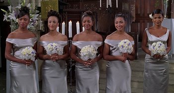 Movie still from “The Best Man” (1999), directed by Malcolm D. Lee – A group of three women holding white flowers in their hands; Medium shot, High angle