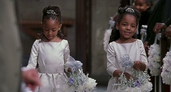 Movie still from “The Best Man” (1999), directed by Malcolm D. Lee – Two little girls in white dresses holding white flowers; Medium shot, High angle