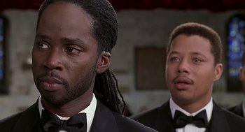 Movie still from “The Best Man” (1999), directed by Malcolm D. Lee – Two men in tuxedos and bow ties looking at the camera; Close Up shot, Low angle