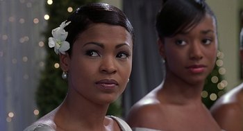 Movie still from “The Best Man” (1999), directed by Malcolm D. Lee – A woman with a white flower in her hair; Close Up shot, Over the shoulder angle