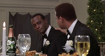 Movie still from “The Best Man” (1999), directed by Malcolm D. Lee – A man in a suit and a man in a suit and a tie; Close Up shot, Over the shoulder angle