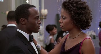 Movie still from “The Best Man” (1999), directed by Malcolm D. Lee – A man and a woman in formal wear looking at one another; Close Up shot, Over the shoulder angle