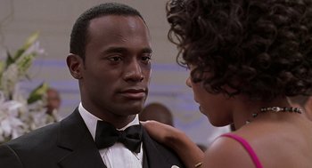 Movie still from “The Best Man” (1999), directed by Malcolm D. Lee – A man in a suit and a woman in a dress; Close Up shot, Over the shoulder angle